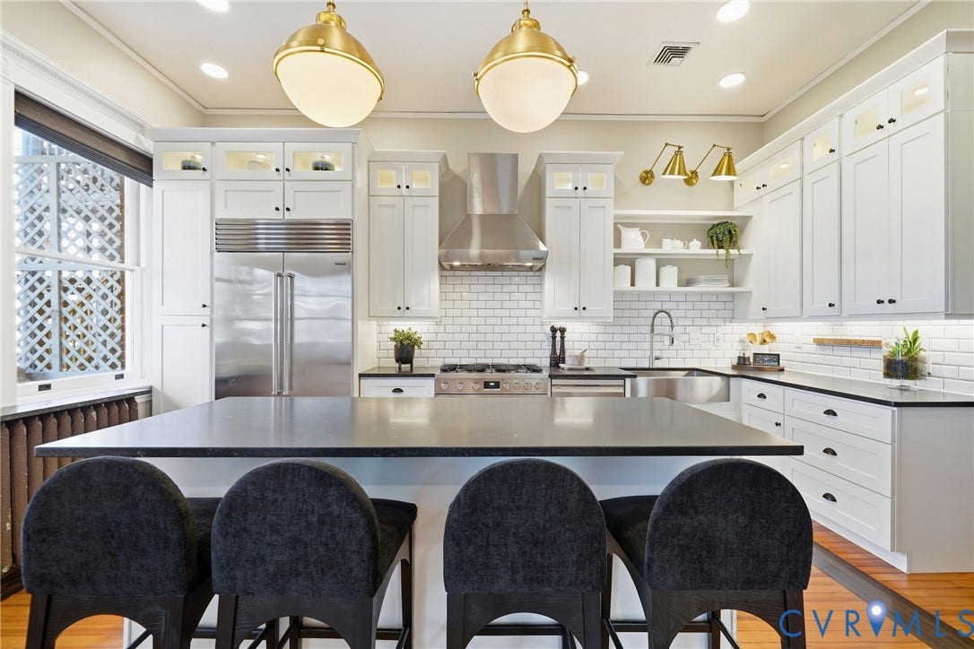 1848 W Grace Street, Historic W. Grace Street, Richmond, VA 23220 Gourmet kitchen featuring a large central island, subway tile backsplash, stainless steel appliances, white cabinetry, and recessed lighting