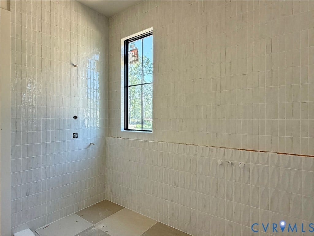 Vertical tile wall installation, contrasting horizontal tile detail, black-framed window