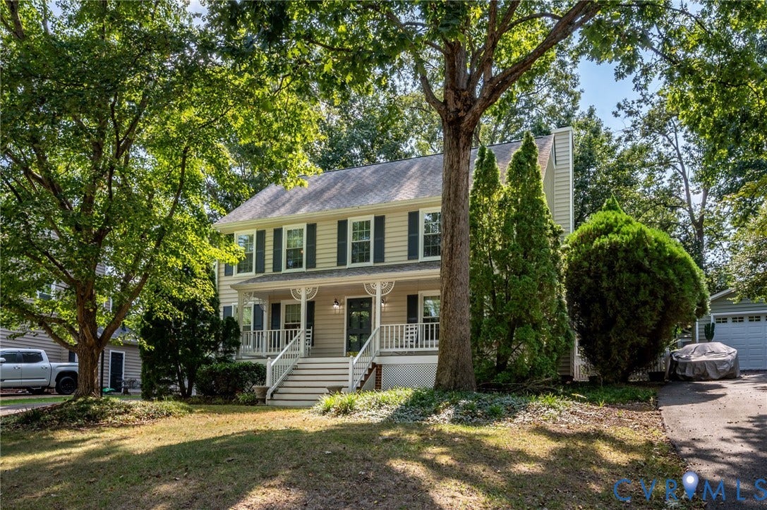 3005 Wiltonshire Drive, Richmond, VA 23233 Two-story traditional residence with light-colored siding, contrasting dark shutters, and a covered front porch featuring white railings