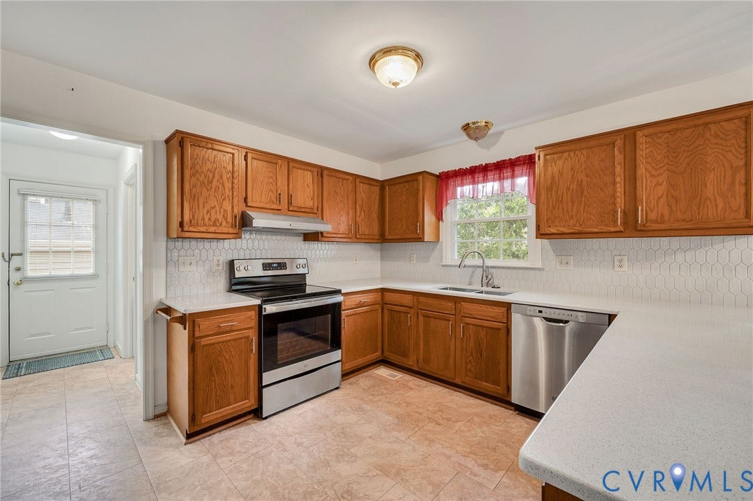 3005 Wiltonshire Drive, Richmond, VA 23233 Wood-finish cabinetry, white countertops, hexagon tile backsplash, stainless steel appliances, and tile flooring