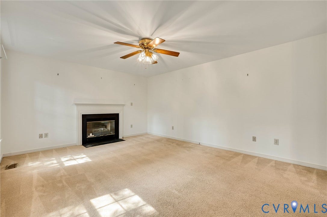 3005 Wiltonshire Drive, Richmond, VA 23233 Living space featuring a fireplace with a white mantel, ceiling fan, and light carpeting