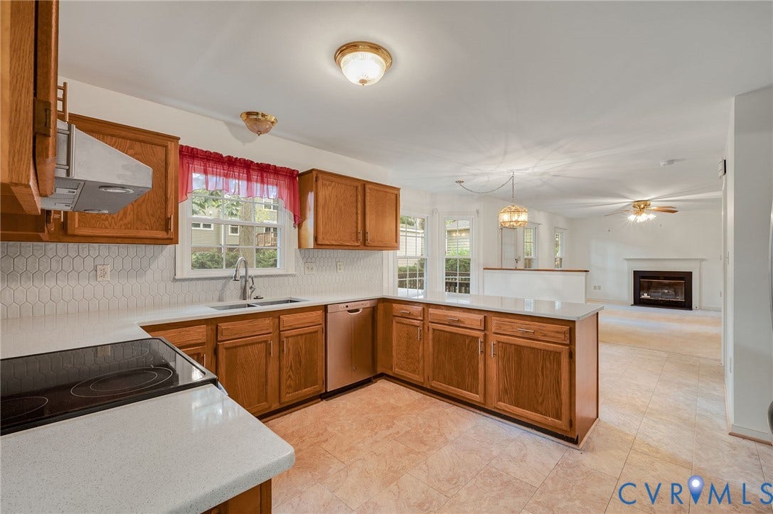 3005 Wiltonshire Drive, Richmond, VA 23233 Kitchen featuring wood cabinetry, solid surface countertops, tile flooring, and a subway tile backsplash