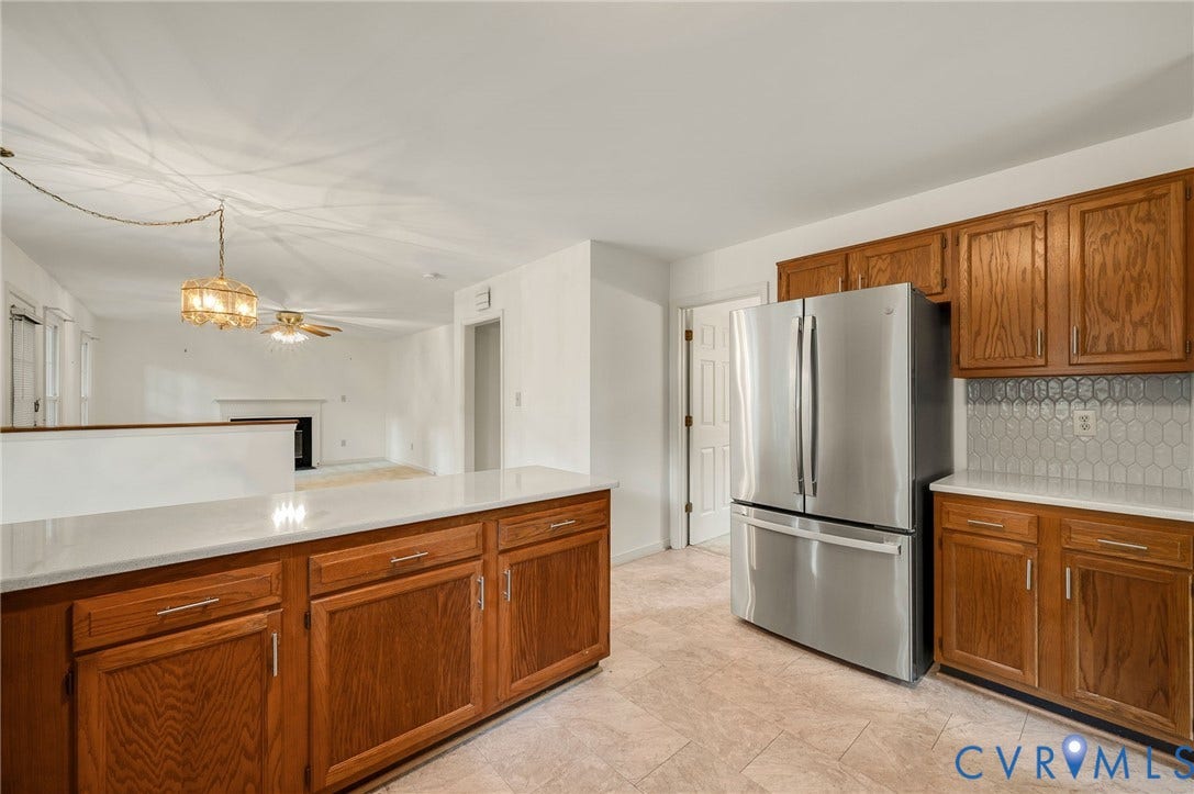 3005 Wiltonshire Drive, Richmond, VA 23233 Kitchen featuring wood cabinetry, white countertops, tile flooring, and a stainless steel refrigerator