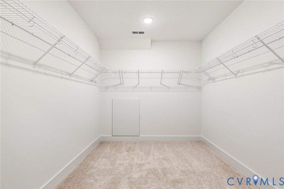 Walk-in closet with carpeted flooring and white wire shelving