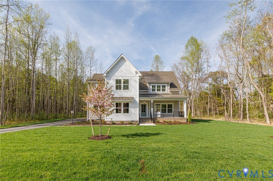 This property features a two-story residence with white siding and a covered front porch