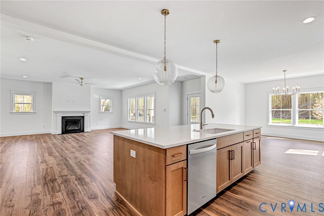 Open concept living space featuring wide plank flooring throughout