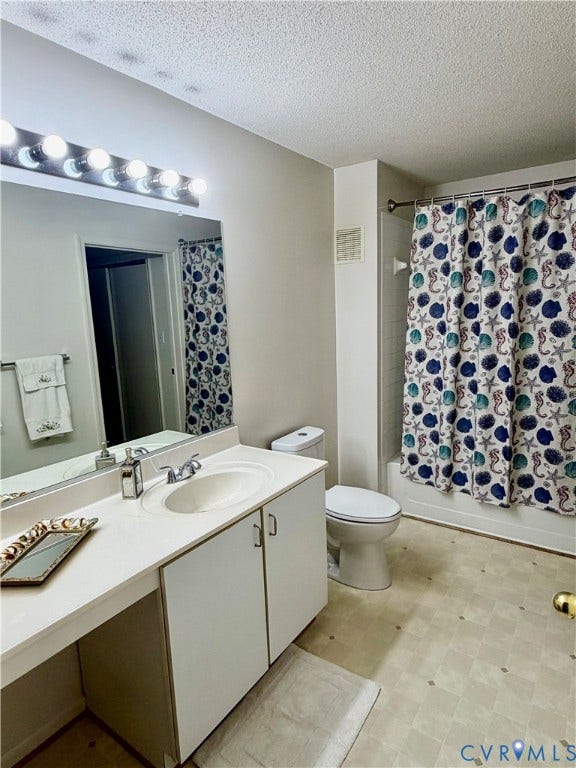 Vanity with integrated sink, overhead lighting, and wall mirror