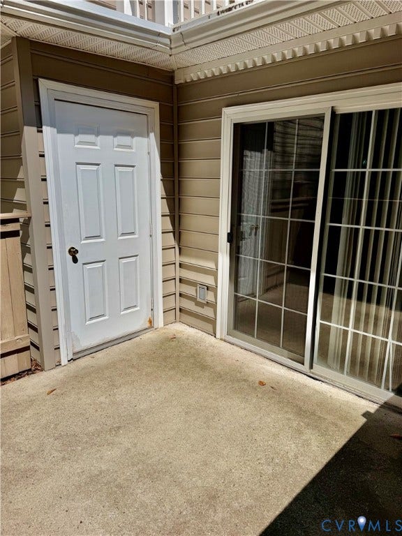 Concrete patio with privacy fence surround.