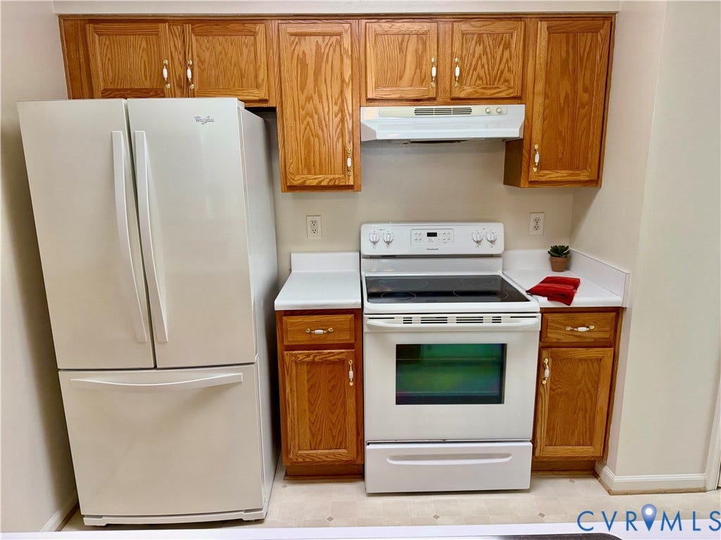 Kitchen featuring wood-finish cabinetry, white countertops, a white refrigerator, a white electric range, and a white range hood