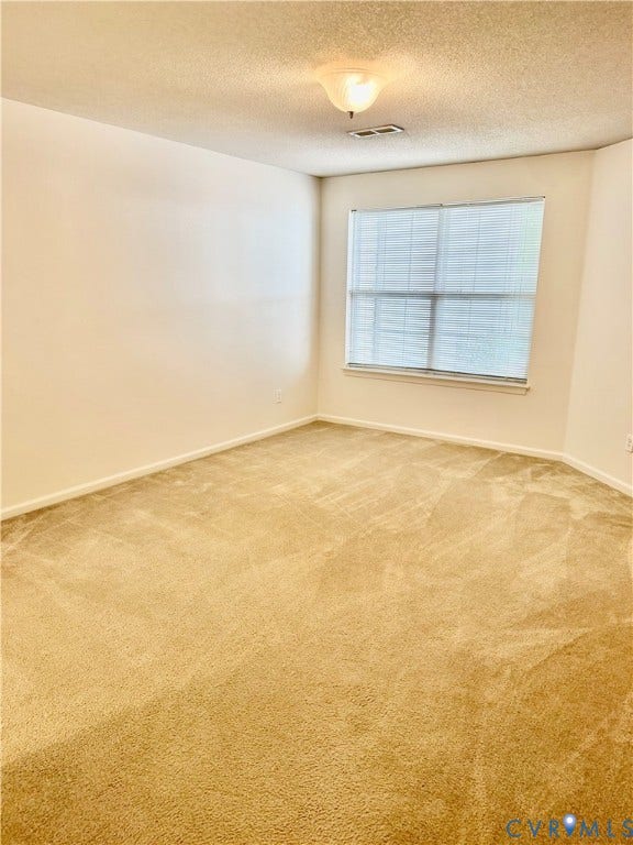 Neutral wall paint, window with blinds, and wall-to-wall carpeting