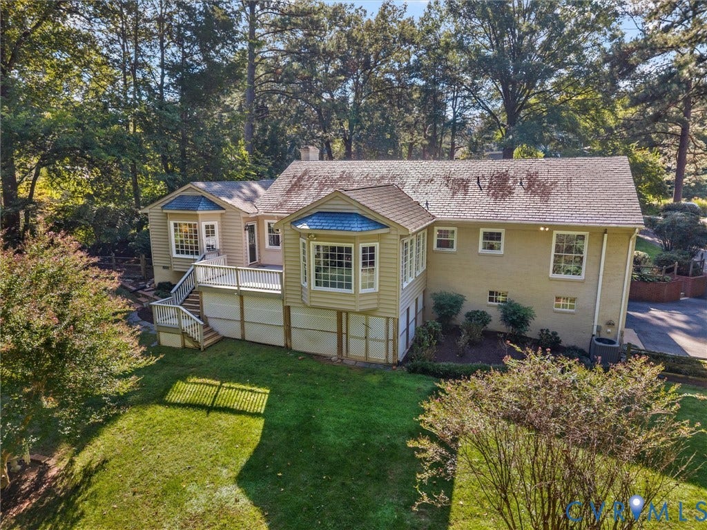 216 Ross Road, Westham Area, Henrico, VA 23229 Expansive backyard featuring a manicured lawn, a multi-level deck with white railings, and mature trees