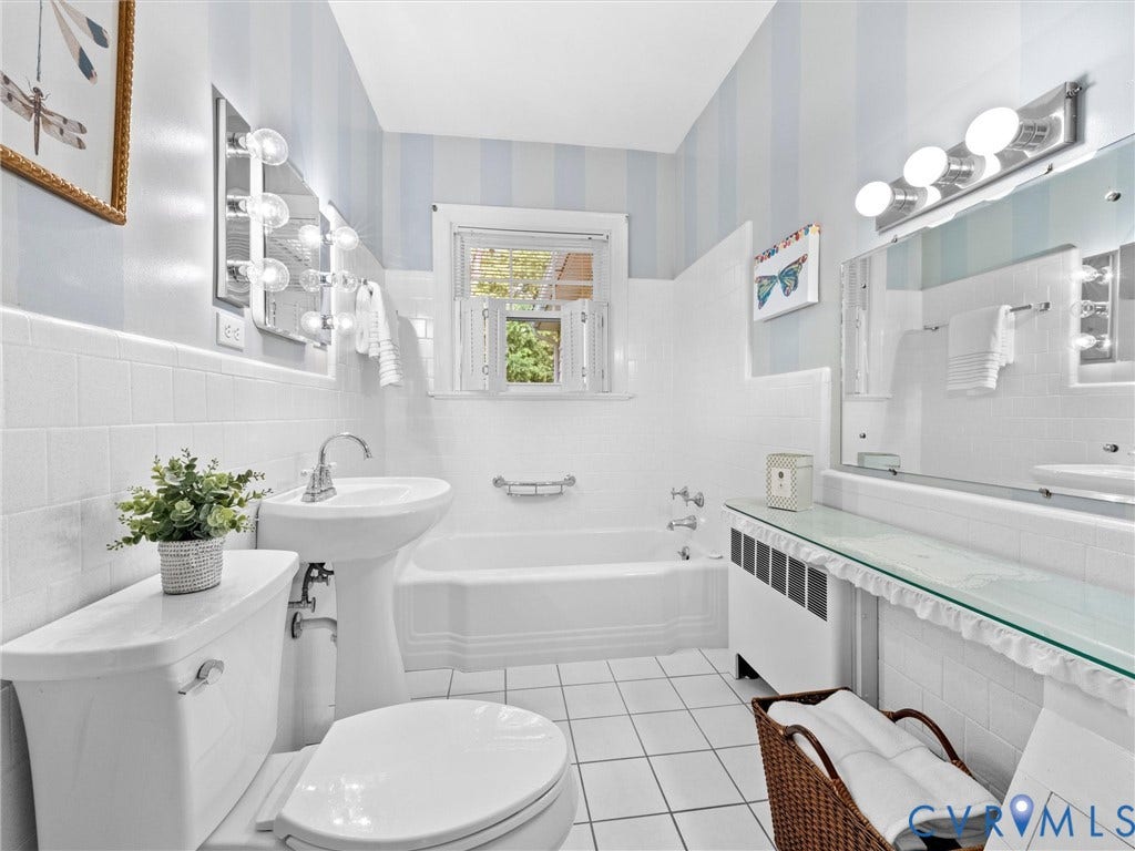 216 Ross Road, Westham Area, Henrico, VA 23229 White tiled bathroom featuring a pedestal sink, white toilet, and built-in bathtub with shower
