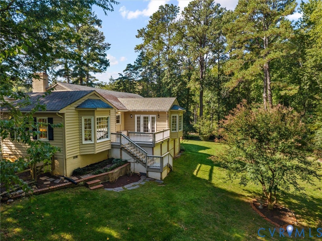 216 Ross Road, Westham Area, Henrico, VA 23229 Exterior featuring a broad deck with white railings, bay windows, and a brick chimney