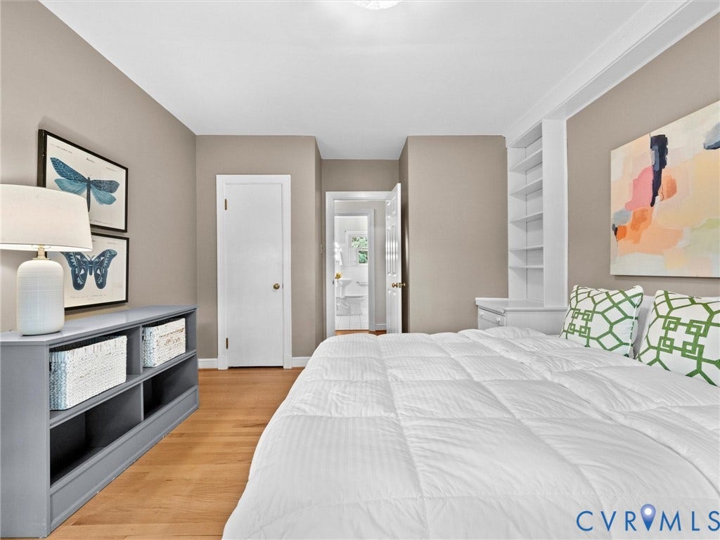 216 Ross Road, Westham Area, Henrico, VA 23229 Hardwood flooring, neutral wall tones, white trim, built-in shelving, and a white interior door