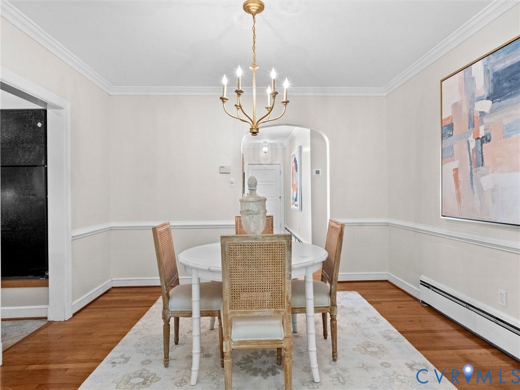 216 Ross Road, Westham Area, Henrico, VA 23229 Hardwood flooring, crown molding, chair rail, and an arched entryway define this space