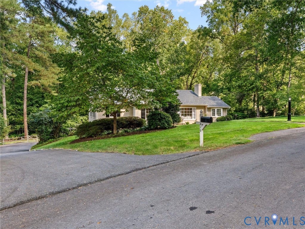 216 Ross Road, Westham Area, Henrico, VA 23229 Traditional-style residence with a prominent chimney, multiple pane windows, and a landscaped front yard with mature trees