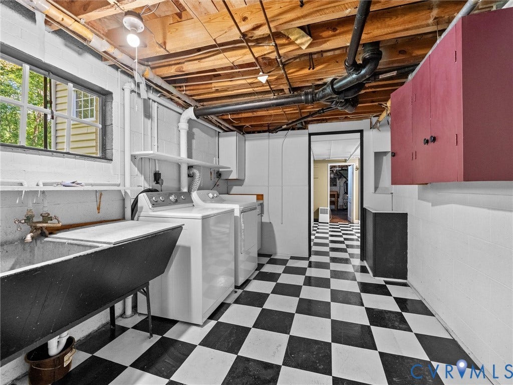 216 Ross Road, Westham Area, Henrico, VA 23229 Laundry room featuring dual front-load washers and dryers, black and white checkered tile flooring, white subway tile walls with burgundy accent paneling, exposed wooden ceiling beams, and a freestanding black soaking tub
