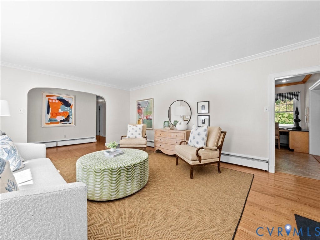 216 Ross Road, Westham Area, Henrico, VA 23229 Hardwood flooring, crown molding, and an arched doorway contribute to the room's character