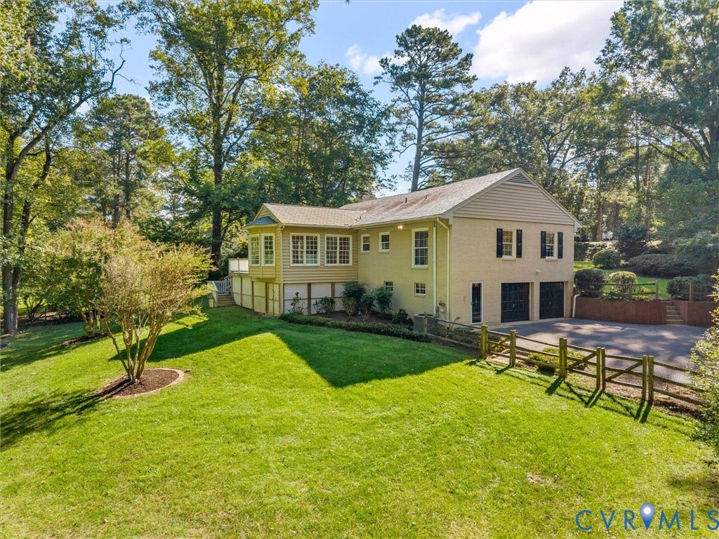 216 Ross Road, Westham Area, Henrico, VA 23229 Brick and siding exterior with a two-car garage, mature trees, manicured lawn, and a sunroom
