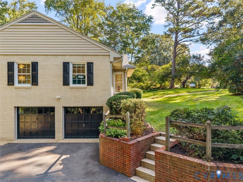 216 Ross Road, Westham Area, Henrico, VA 23229 Charming brick-and-siding Colonial with dual black garage doors, multi-pane windows with black shutters, and a gabled roofline