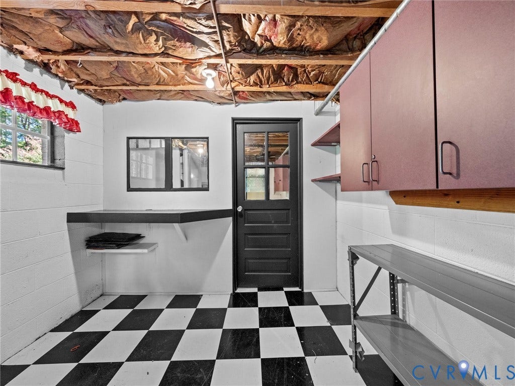 216 Ross Road, Westham Area, Henrico, VA 23229 Utility kitchen featuring classic black-and-white checkered tile flooring, white subway tile walls with black trim detail, pink cabinetry with wood countertop, stainless steel sink, and direct access to exterior entry with multi-pane glass door