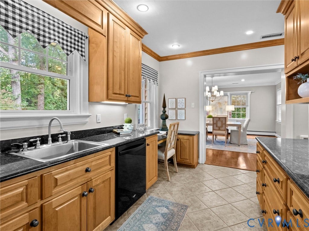 216 Ross Road, Westham Area, Henrico, VA 23229 Wood-finish cabinetry, dark countertops, tiled flooring, recessed lighting, and a stainless steel sink with a gooseneck faucet