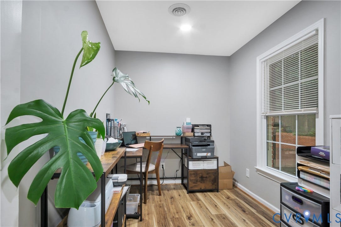 Recessed lighting, wood-finish flooring, and a window with white blinds