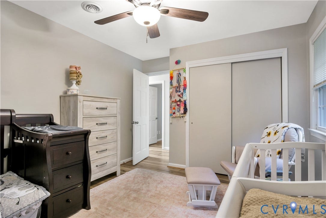 Recessed ceiling light, ceiling fan with light fixture, neutral wall paint, wood-finish flooring, and sliding closet doors