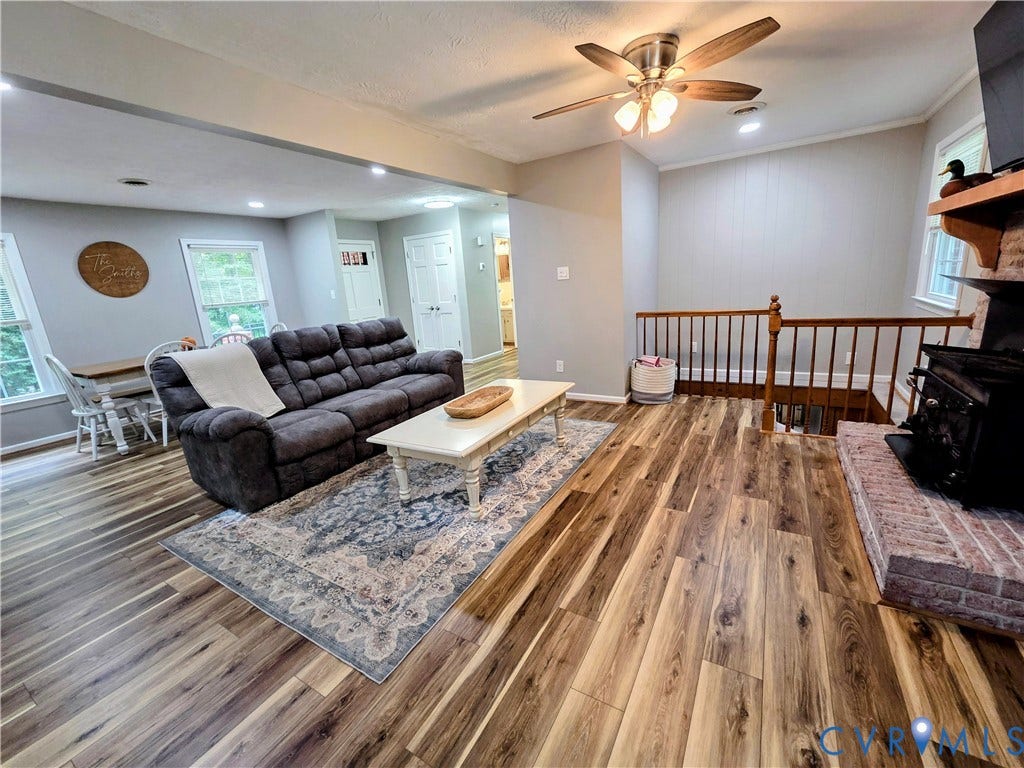 Wood-finish flooring throughout, with recessed lighting and a ceiling fan