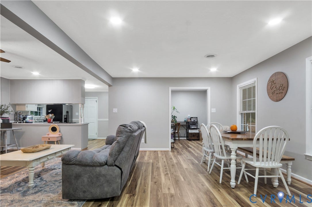 Wood-finish flooring throughout, recessed lighting, and a defined dining area with a window