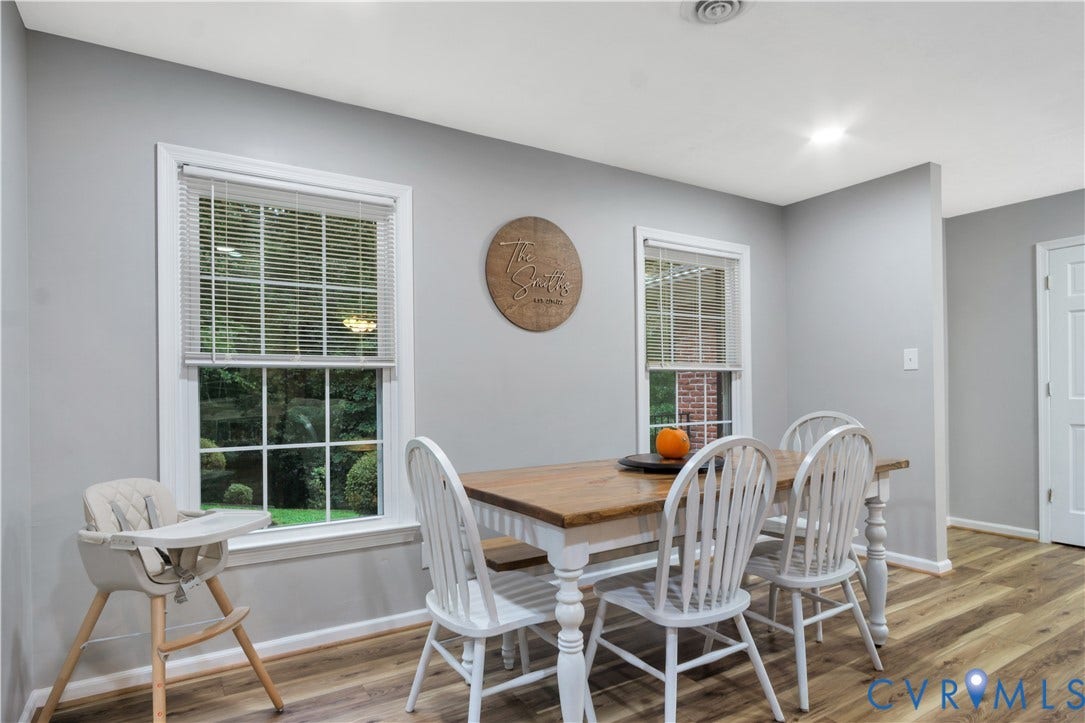 Wood-finish flooring throughout, complemented by light gray walls