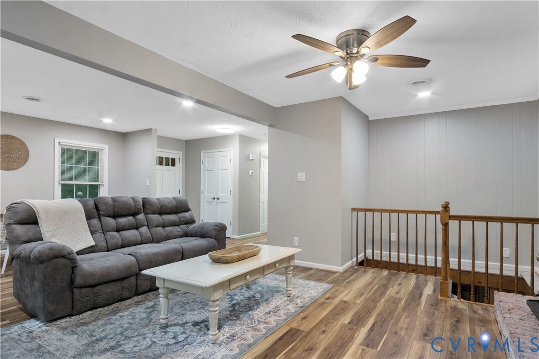 Recessed lighting, wood-finish flooring, ceiling fan with light, interior railing, and white trim