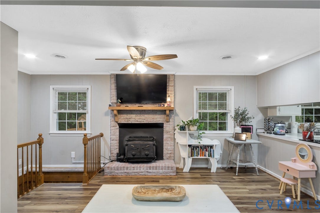 Living area with wood-finish flooring and a ceiling fan