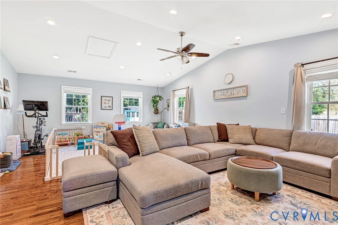 Vaulted ceiling with recessed lighting and ceiling fan, wood-finish flooring, and multiple windows