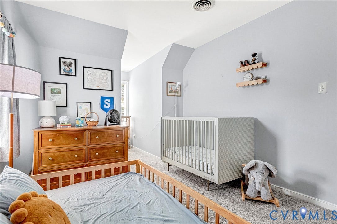 Sloped ceilings, recessed lighting, wood-finish dresser, and light-tone carpeting