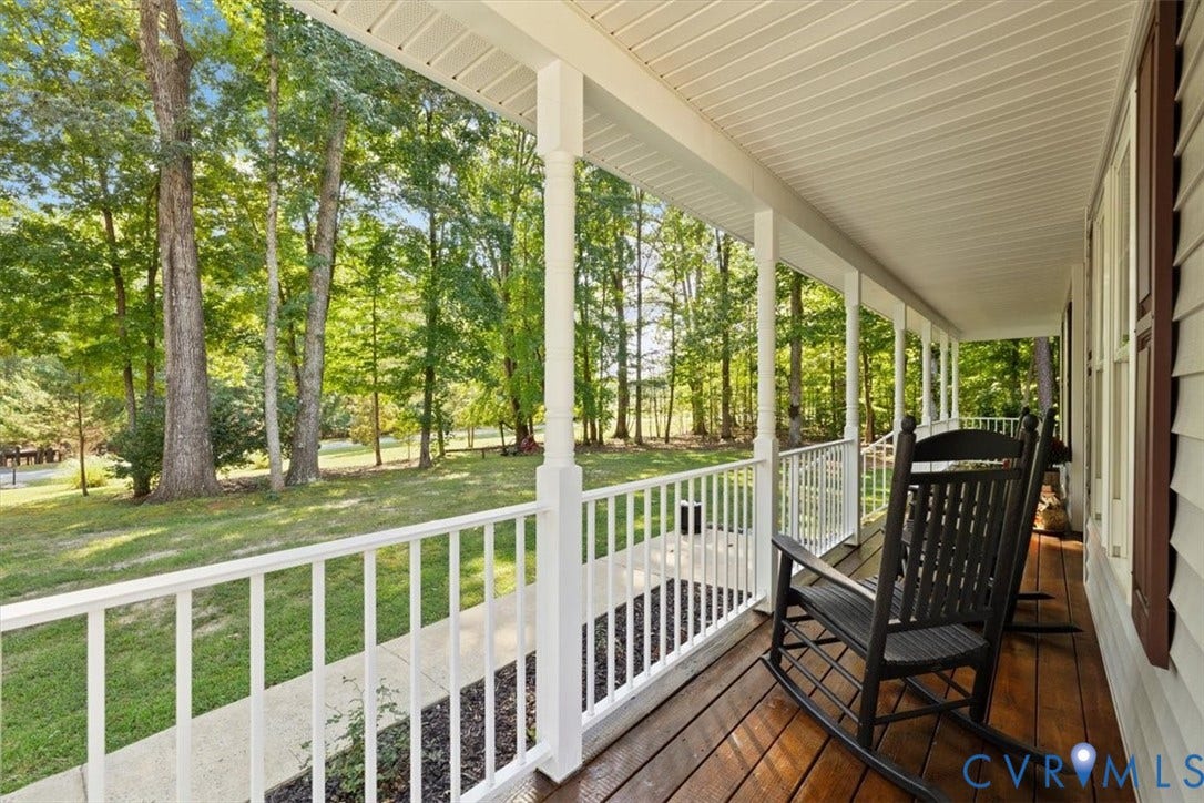 4398 Lynnecross Court, Powhatan, VA 23139 Expansive covered porch featuring a wood deck, white railings, and multiple support columns
