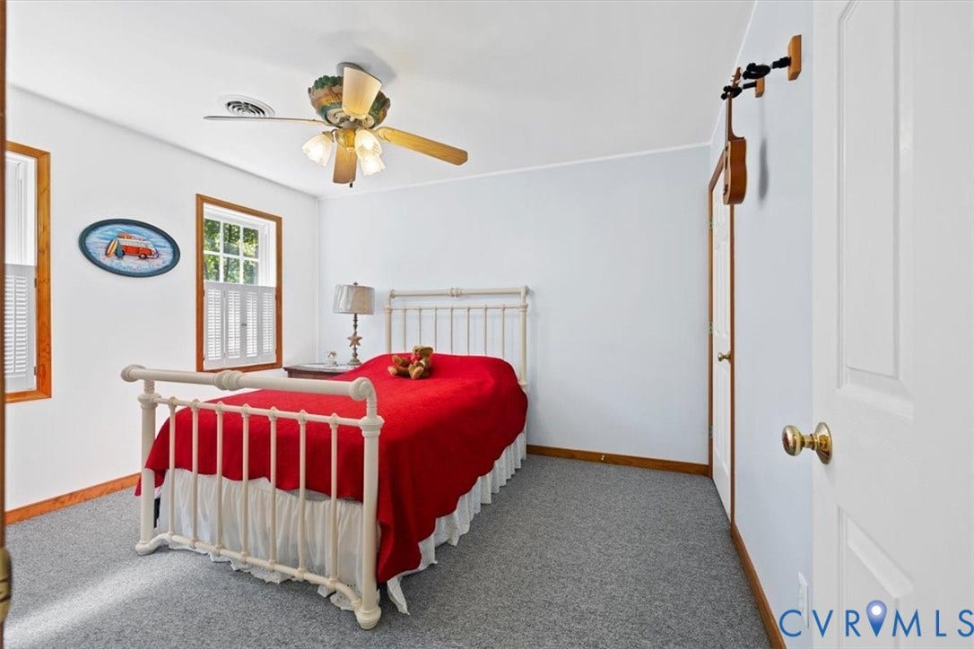 4398 Lynnecross Court, Powhatan, VA 23139 Two windows with wood trim, a ceiling fan with integrated lighting, and light gray carpeting