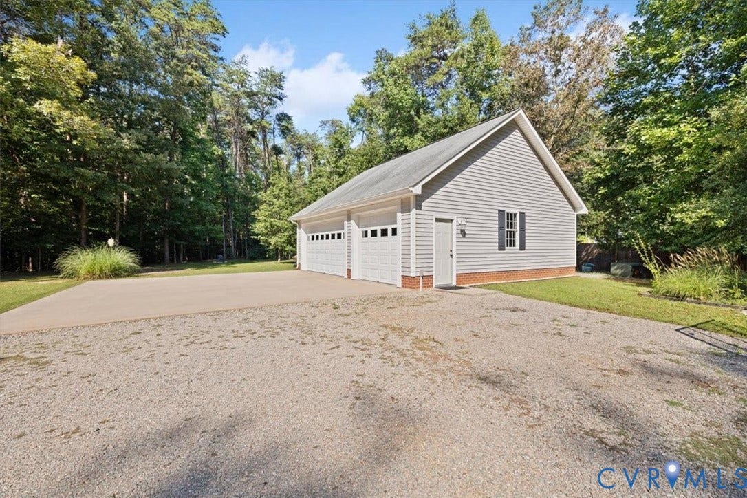 4398 Lynnecross Court, Powhatan, VA 23139 Detached two-door garage with light gray siding, white garage doors, and a side entry door