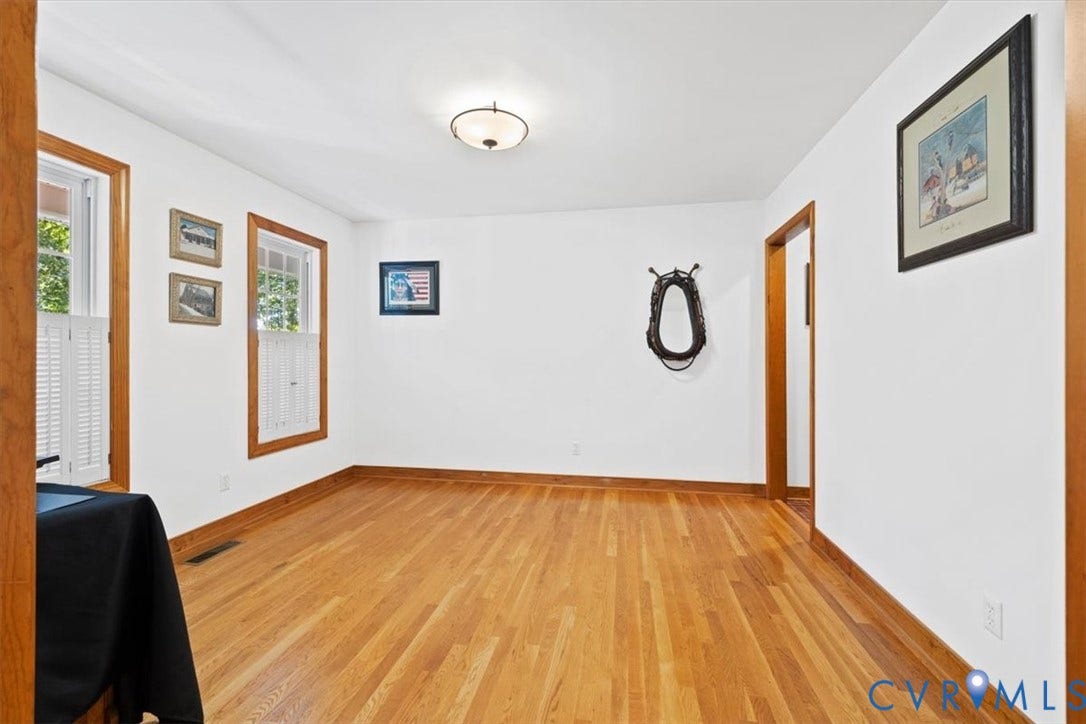 4398 Lynnecross Court, Powhatan, VA 23139 Hardwood flooring, wood trim, two windows, and a flush mount ceiling light fixture