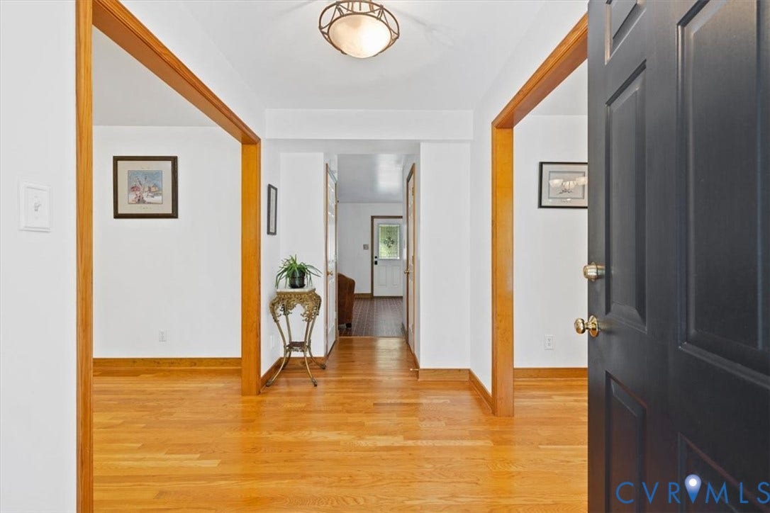 4398 Lynnecross Court, Powhatan, VA 23139 Hardwood flooring throughout, white painted walls, and wood-trimmed archways