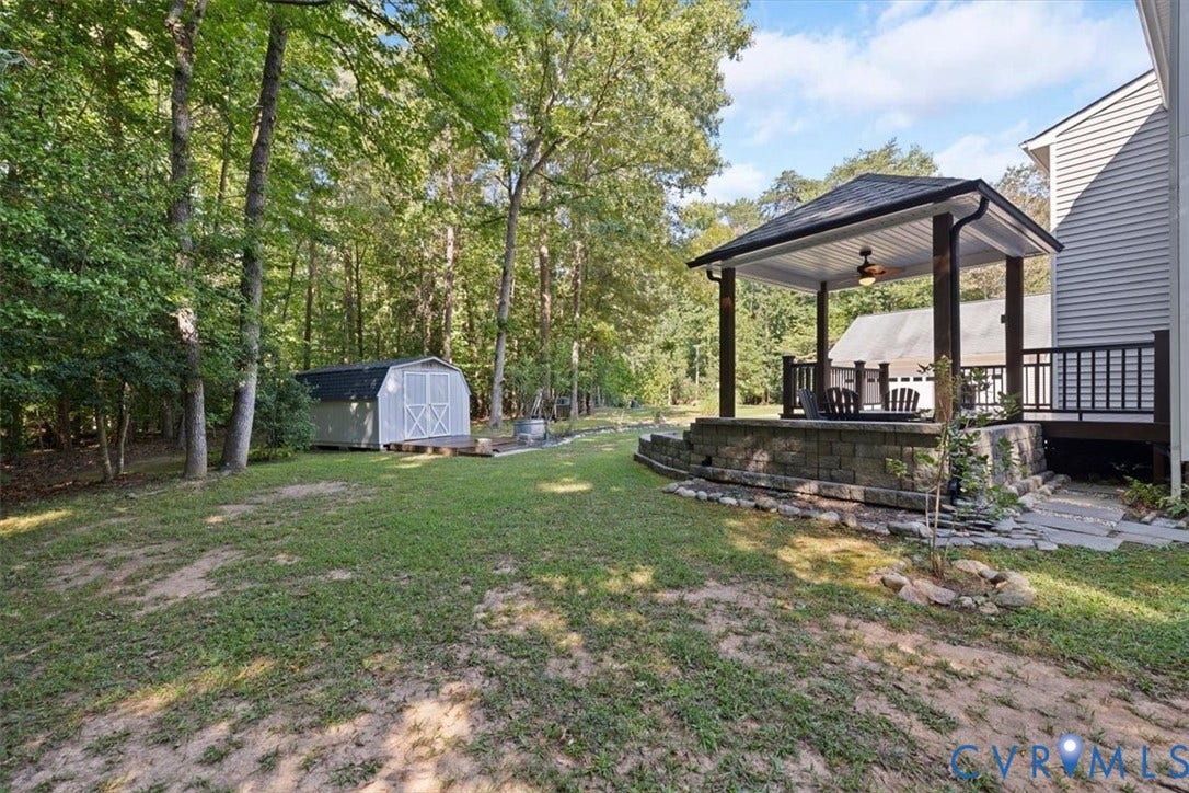4398 Lynnecross Court, Powhatan, VA 23139 Covered outdoor patio with exposed beams, wood railing, and ceiling fan