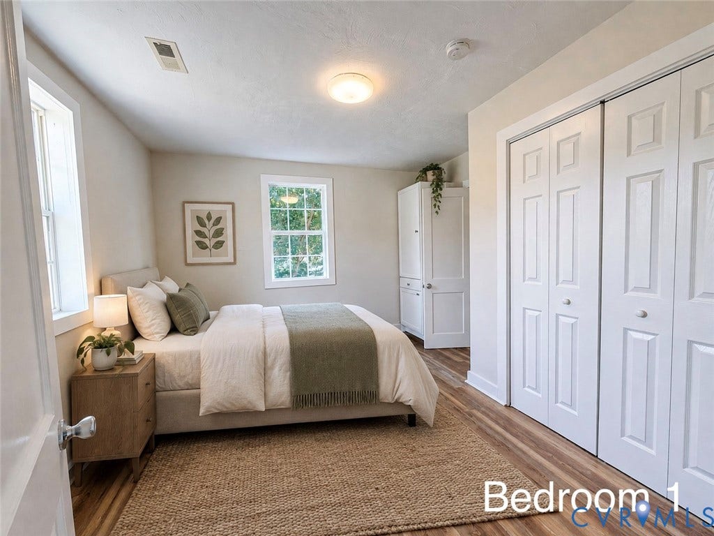 VIRTUALLY STAGED; Wood-finish flooring, two windows with white trim, and bi-fold closet doors