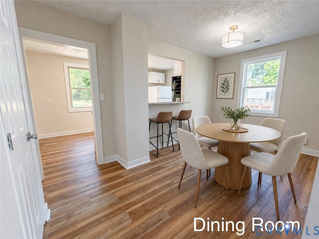 VIRTUALLY STAGED; Wood-finish flooring throughout, framed window with natural light, recessed opening, white trim, and a semi-flush mount ceiling fixture