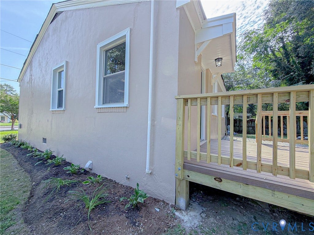 Newly constructed wood deck with railing and exterior lighting