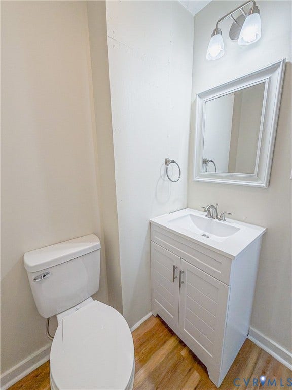 White vanity with slat-front doors, integrated sink, and brushed nickel faucet