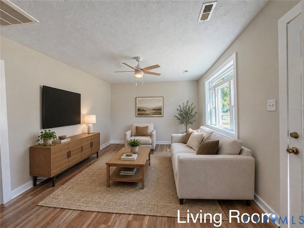 VIRTUALLY STAGED; Wood-finish flooring, ceiling fan with integrated lighting, recessed wall space, single window, and a white paneled door
