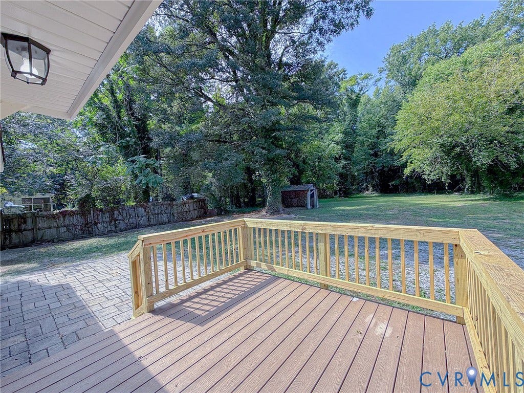 Expansive rear deck featuring composite decking and natural wood railings