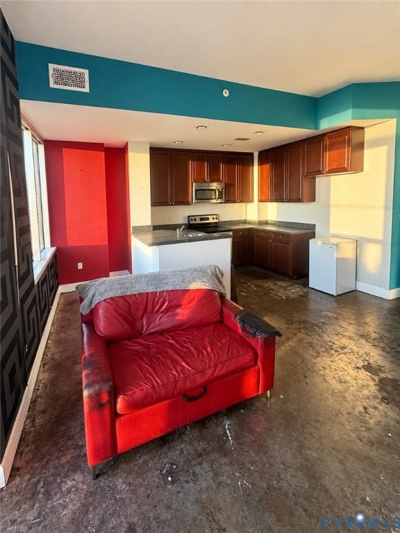 301 Virginia Street, #U703, Richmond, VA 23219 Dark wood-finish cabinetry with stainless steel appliances, dark countertops, and recessed lighting