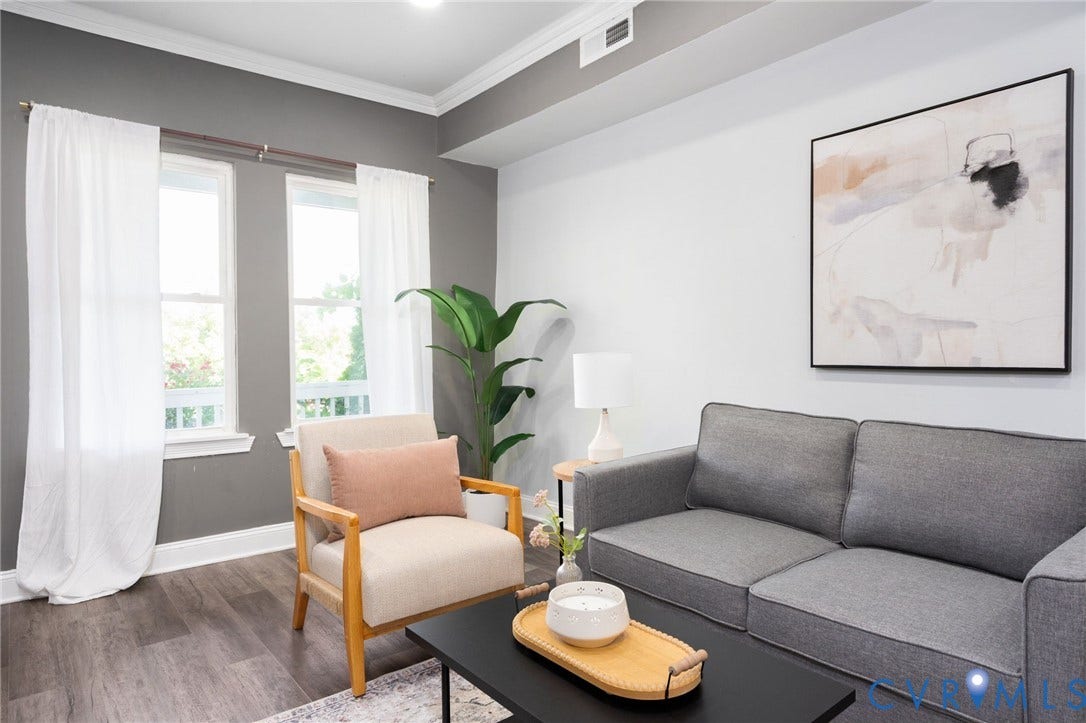 Wood-finish flooring, white crown molding, recessed lighting, and dual windows