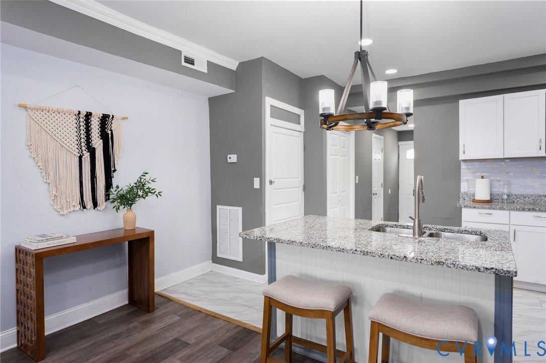 Kitchen island with granite countertop, stainless steel sink, and gooseneck faucet